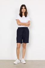 Load image into Gallery viewer, Woman wearing a white t-shirt and navy cotton shorts against a white background