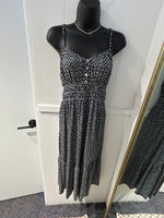 Load image into Gallery viewer, Black and white patterned dress with adjustable spaghetti straps and faux button detail.