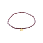 Load image into Gallery viewer, Purple beaded bracelet with a gold tag on a white background