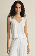 Load image into Gallery viewer, Woman wearing a white sleeveless top and white pants against a beige background