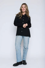 Load image into Gallery viewer, Woman wearing a black button shirt.