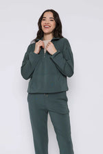 Load image into Gallery viewer, Woman wearing a green 1/2 zip mock neck sweatshirt against a white background