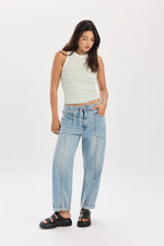 Load image into Gallery viewer, Woman wearing light blue barrel jeans with drawstring at waist