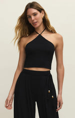 Load image into Gallery viewer, Woman wearing a black halter top and black pants on a beige background