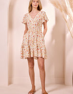 Load image into Gallery viewer, Woman wearing an A-line mini floral dress against a plain background