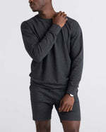 Load image into Gallery viewer, Person wearing a black heather sweatshirt and shorts on a white background