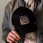 Load image into Gallery viewer, Person holding a black cap with an owl design and 'WISE ASS' text.
