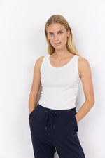 Load image into Gallery viewer, Woman wearing an off-white tank top and navy pants against a white background

