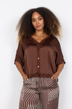 Load image into Gallery viewer, Brown tee featuring short sleeves, a V-neckline, and buttons down the front.
