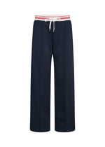 Load image into Gallery viewer, Navy blue pants with a red and white striped waistband on a white background
