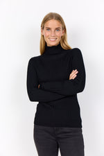 Load image into Gallery viewer, Woman wearing a black ribbed  turtleneck sweater against a white background
