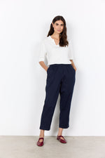 Load image into Gallery viewer, Woman wearing a white blouse and elastic waistband navy pants against a white background

