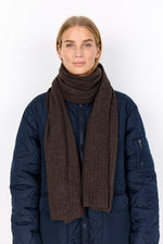 Load image into Gallery viewer, Woman wearing a dark blue coat and brown scarf on a white background
