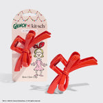 Load image into Gallery viewer, Red bow claw clip with packaging featuring 'The Grinch' branding on a light gray background.
