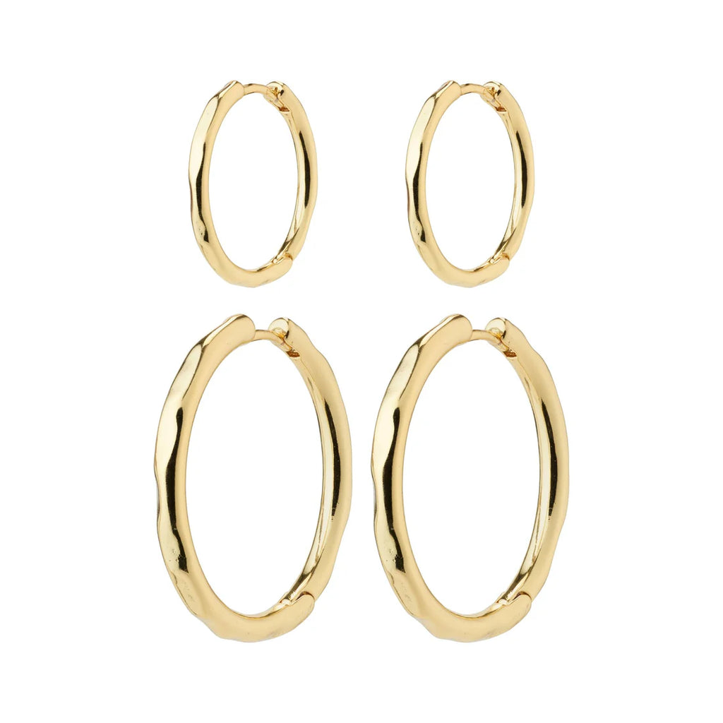 Set of gold hoop earrings on a white background. Huggie closure. 