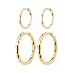 Set of gold hoop earrings on a white background. Huggie closure. 