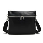 Load image into Gallery viewer, Black vegan leather crossbody bag with zippered front pocket. 
