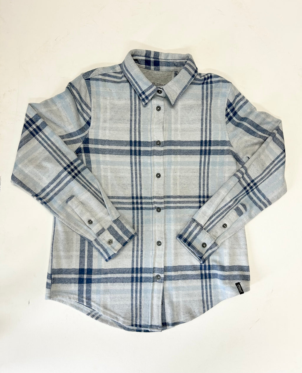 Plaid shirt with blue and gray pattern on a white background