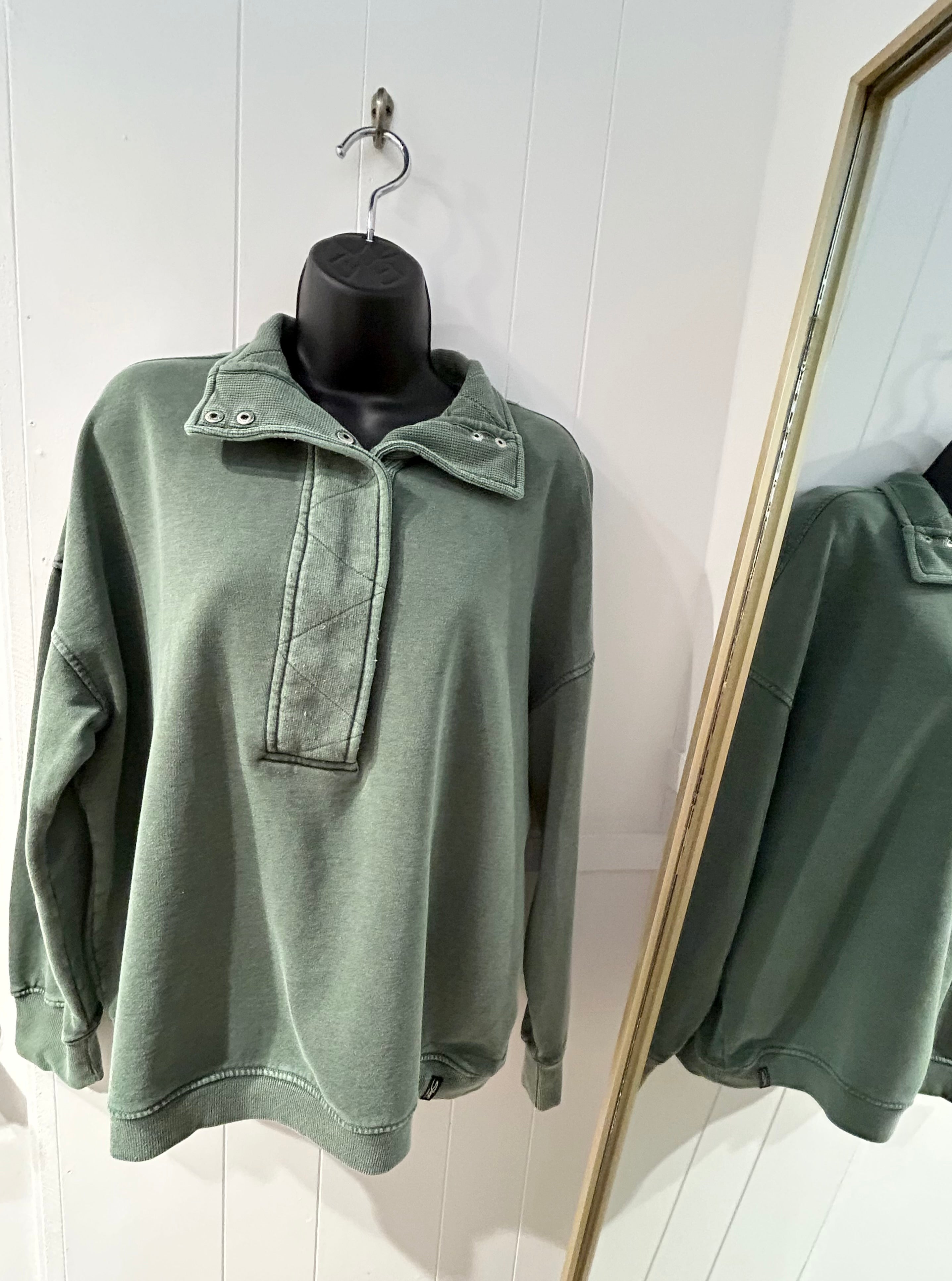 Green half mock neck pullover.