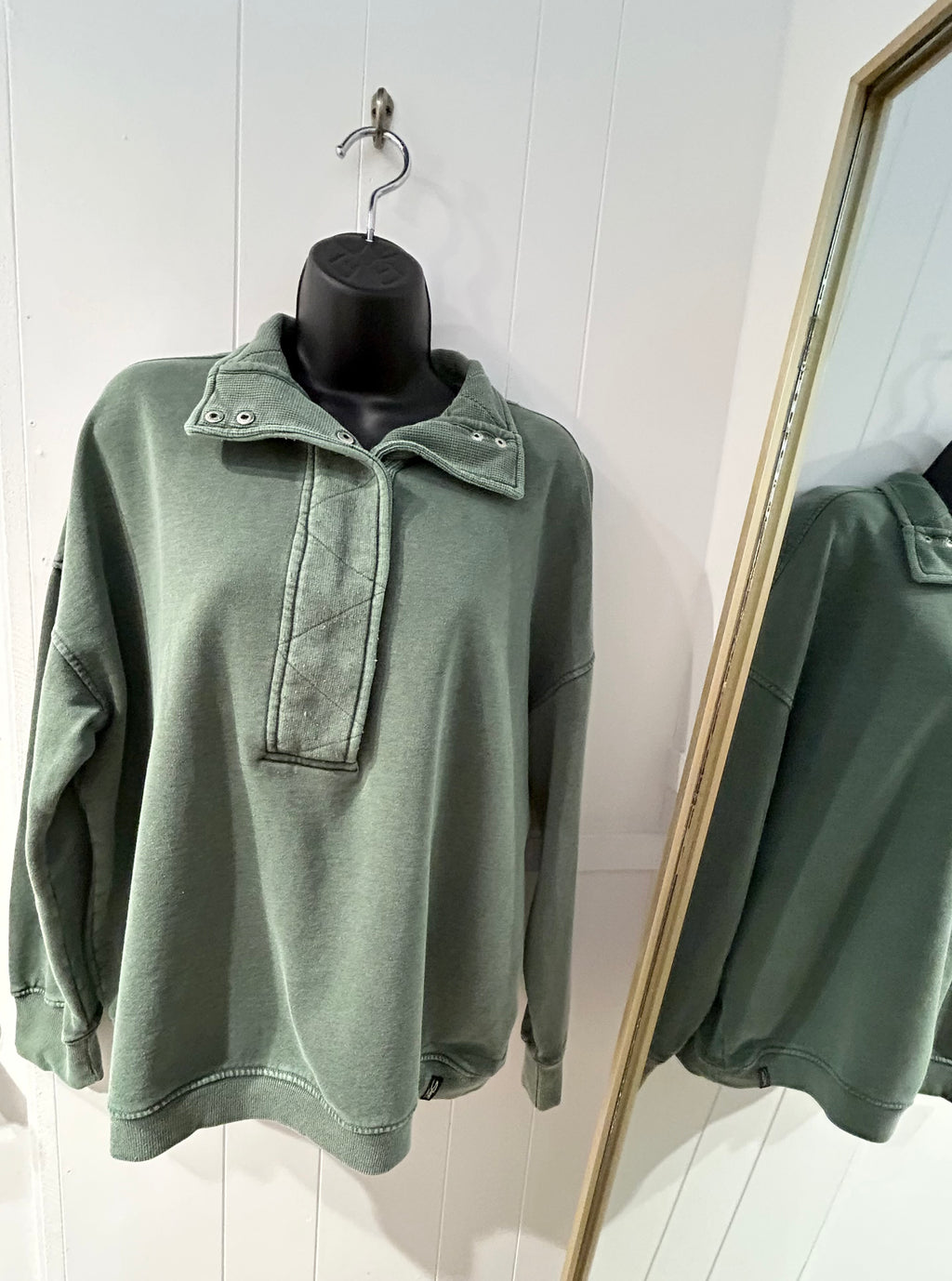 Green half mock neck pullover.