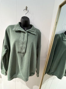 Green half mock neck pullover.
