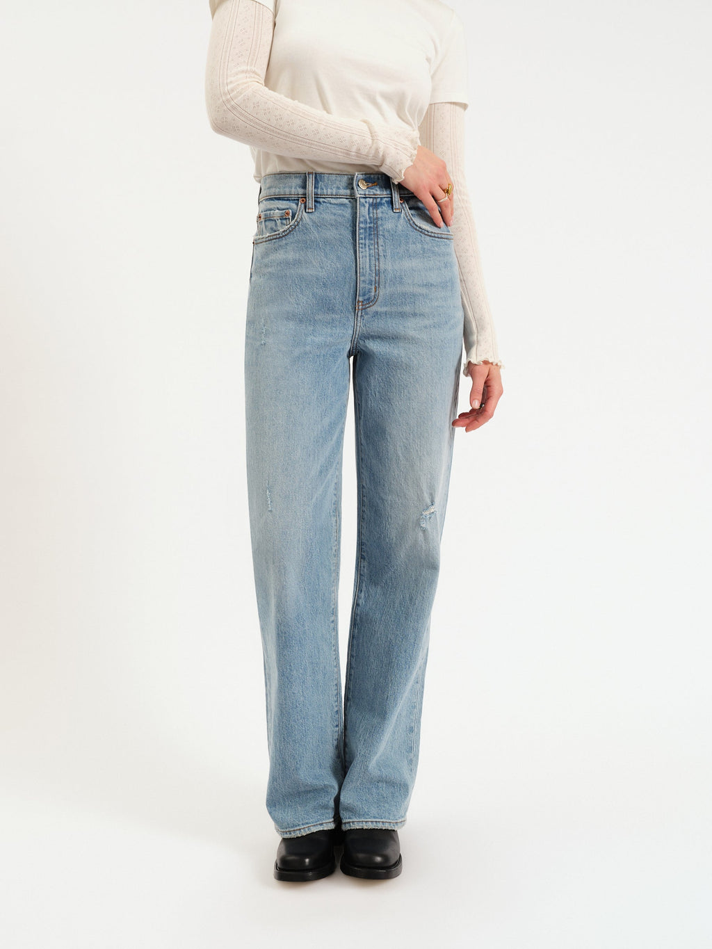 Denim jeans with a high waist, straight legs, and finished hem. 