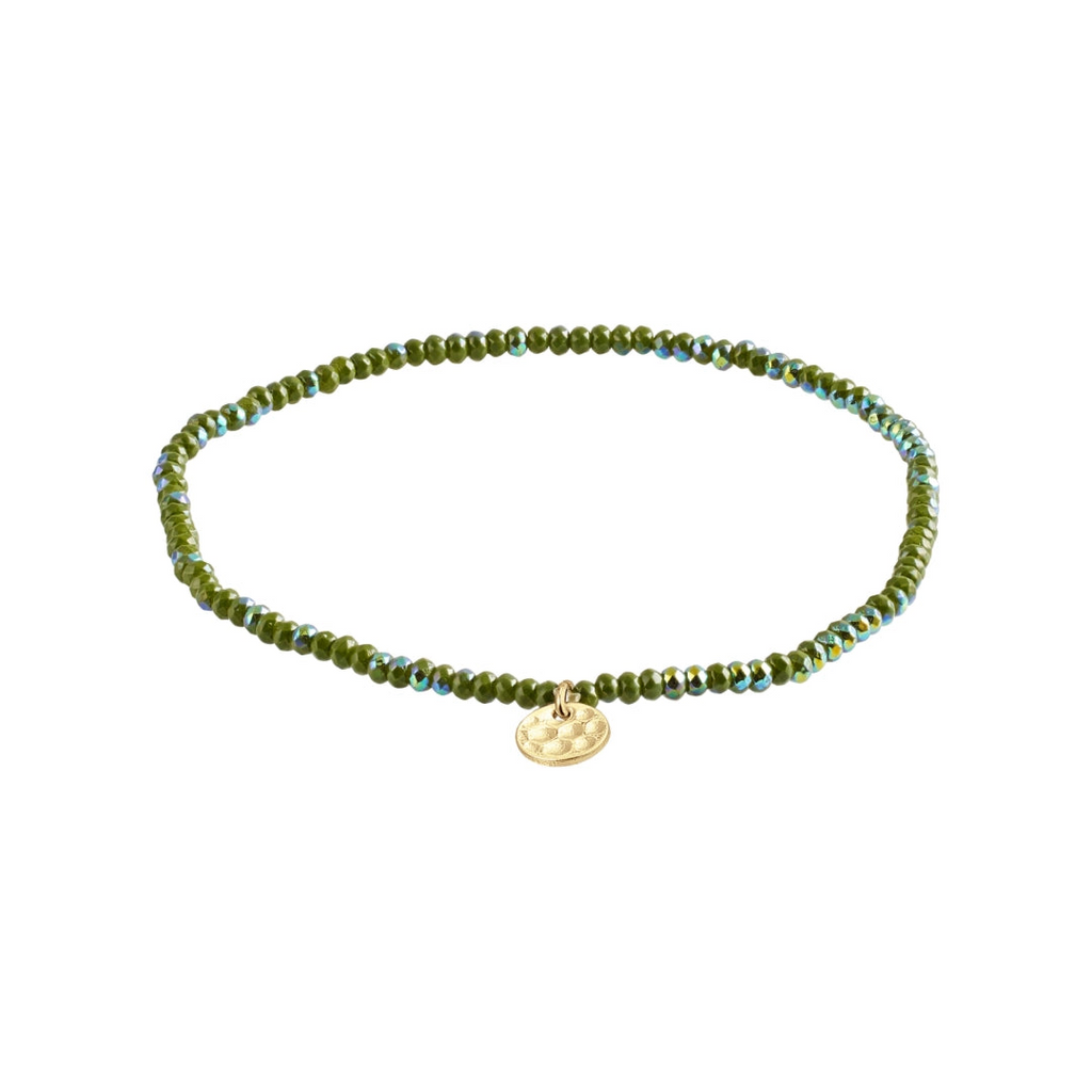 Green beaded bracelet with a gold charm on a white background