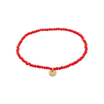 Load image into Gallery viewer, Red beaded bracelet with a gold charm on a white background
