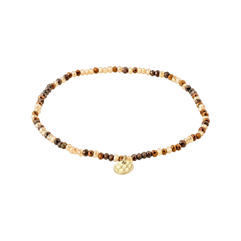 Bracelet with brown and beige beads and a gold charm on a white background
