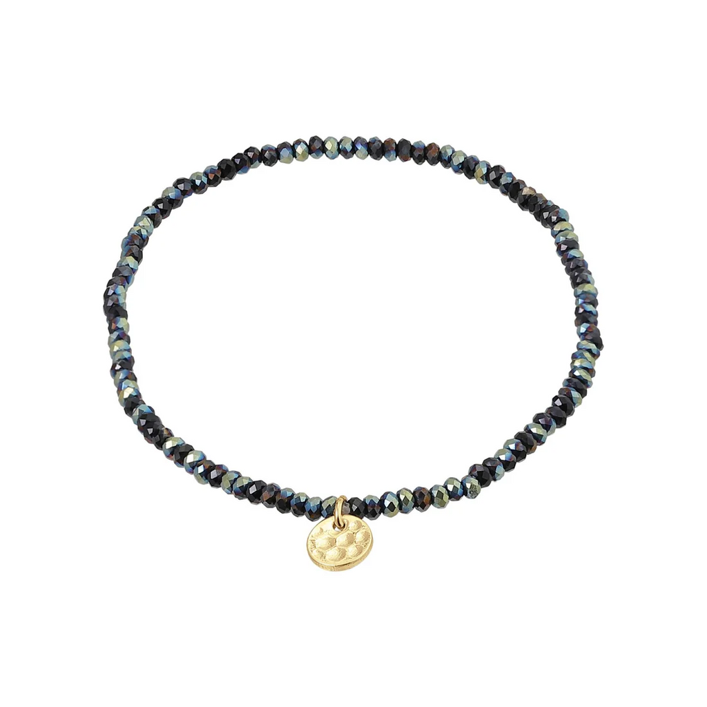 Dark grey beaded bracelet with a gold charm on a white background
