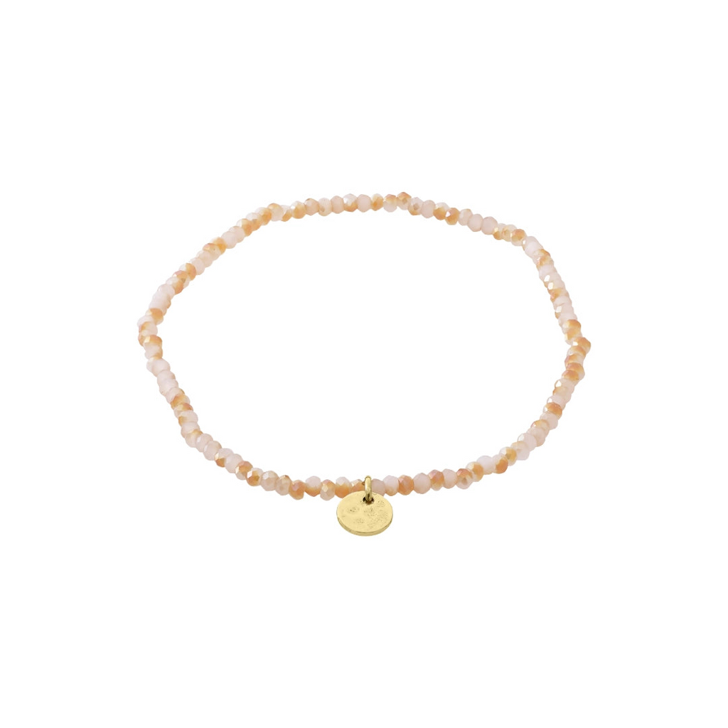 Beaded bracelet in shades of pink with a gold charm on a white background