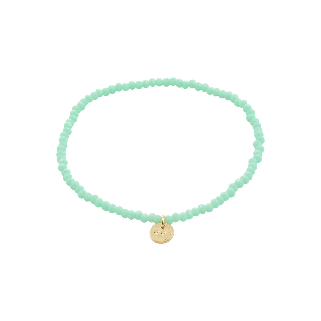 Mint green beaded bracelet with a gold charm on a white background