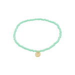 Load image into Gallery viewer, Mint green beaded bracelet with a gold charm on a white background
