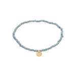 Load image into Gallery viewer, Dusty blue beaded bracelet with a gold charm on a white background
