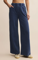 Load image into Gallery viewer, Person wearing blue knit denim wide-leg pants on a beige background
