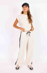 Load image into Gallery viewer, Wide leg beige pants with black stripe and drawstring.   
