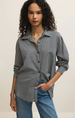 Load image into Gallery viewer, Woman wearing a black and white checkered shirt with rolled-up sleeves and blue jeans on a plain background
