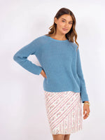 Load image into Gallery viewer, Woman wearing a blue knit sweater and floral skirt on a white background
