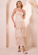 Load image into Gallery viewer, Woman wearing a floral midi dress against a neutral background
