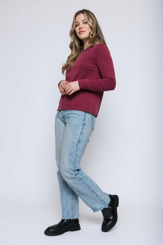 Woman wearing a wine long-sleeve crewneck tee