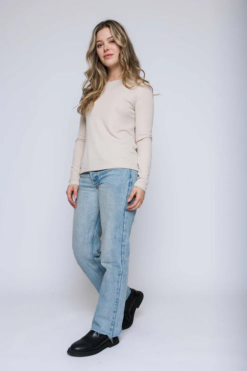 Woman wearing a stone long-sleeve crewneck tee
