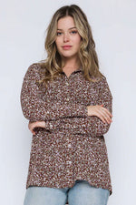 Load image into Gallery viewer, Woman wearing a brown floral blouse against a white background
