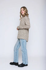 Load image into Gallery viewer, Woman wearing a green pattern blouse. 
