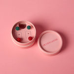Load image into Gallery viewer, Pink jewelry box with a set of red and green sparkle ball stud earrings on a pink background
