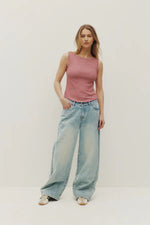 Load image into Gallery viewer, Woman wearing a striped red tank top and light blue jeans on a white background
