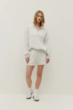 Load image into Gallery viewer, Person wearing a light gray 1/4 zip sweater and shorts set on a white background
