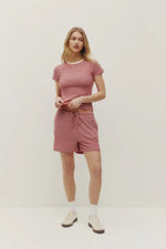 Load image into Gallery viewer, Woman wearing a red and white striped tee and shorts on a plain background
