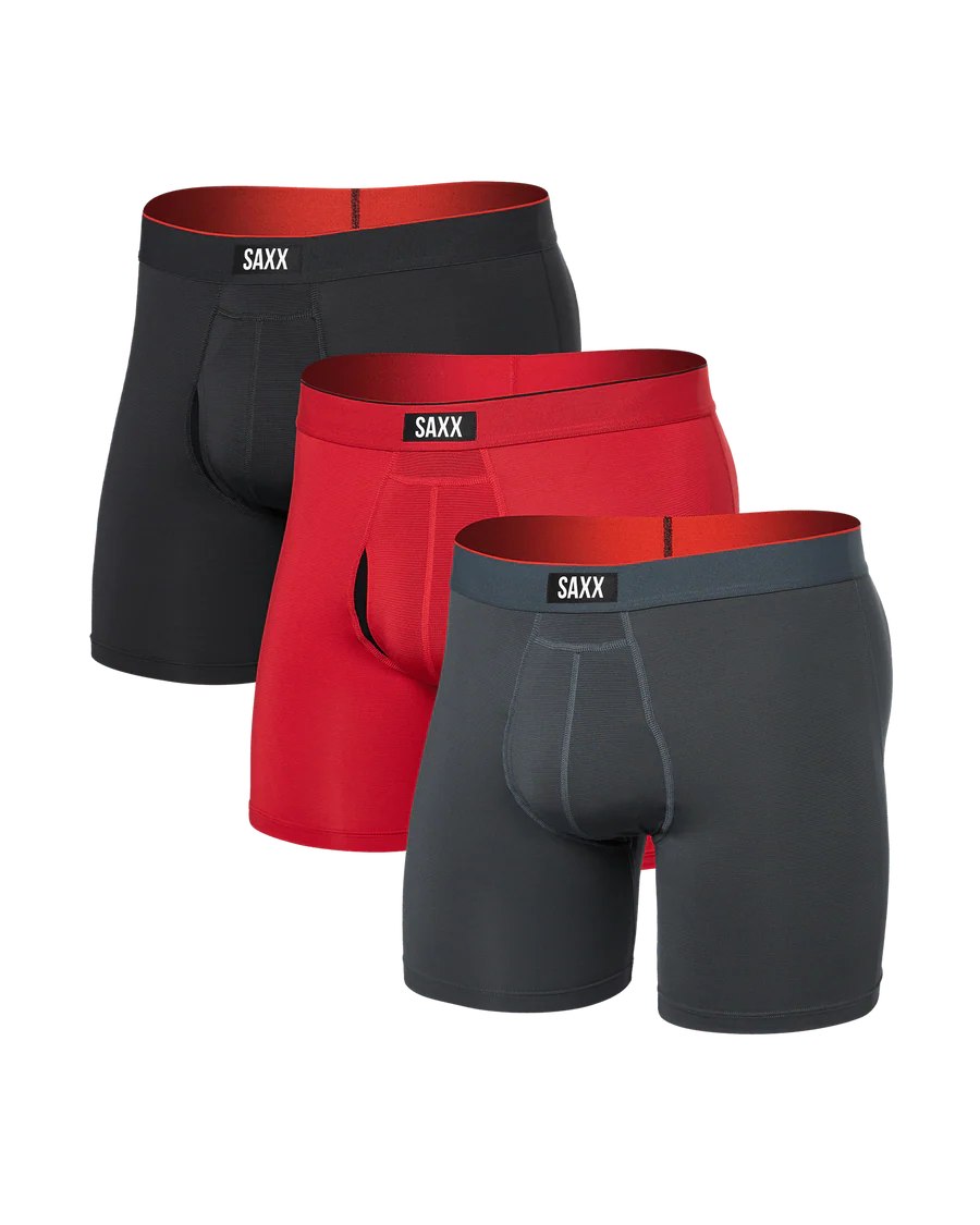 Three pairs of SAXX boxer briefs in black, red, and gray on a white background.