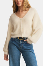 Load image into Gallery viewer, Woman wearing a cream sweater cardigan and blue jeans on a white background
