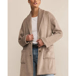 Load image into Gallery viewer, Woman wearing a beige coat that has a shawl neckline, front pockets, and button closure. 
